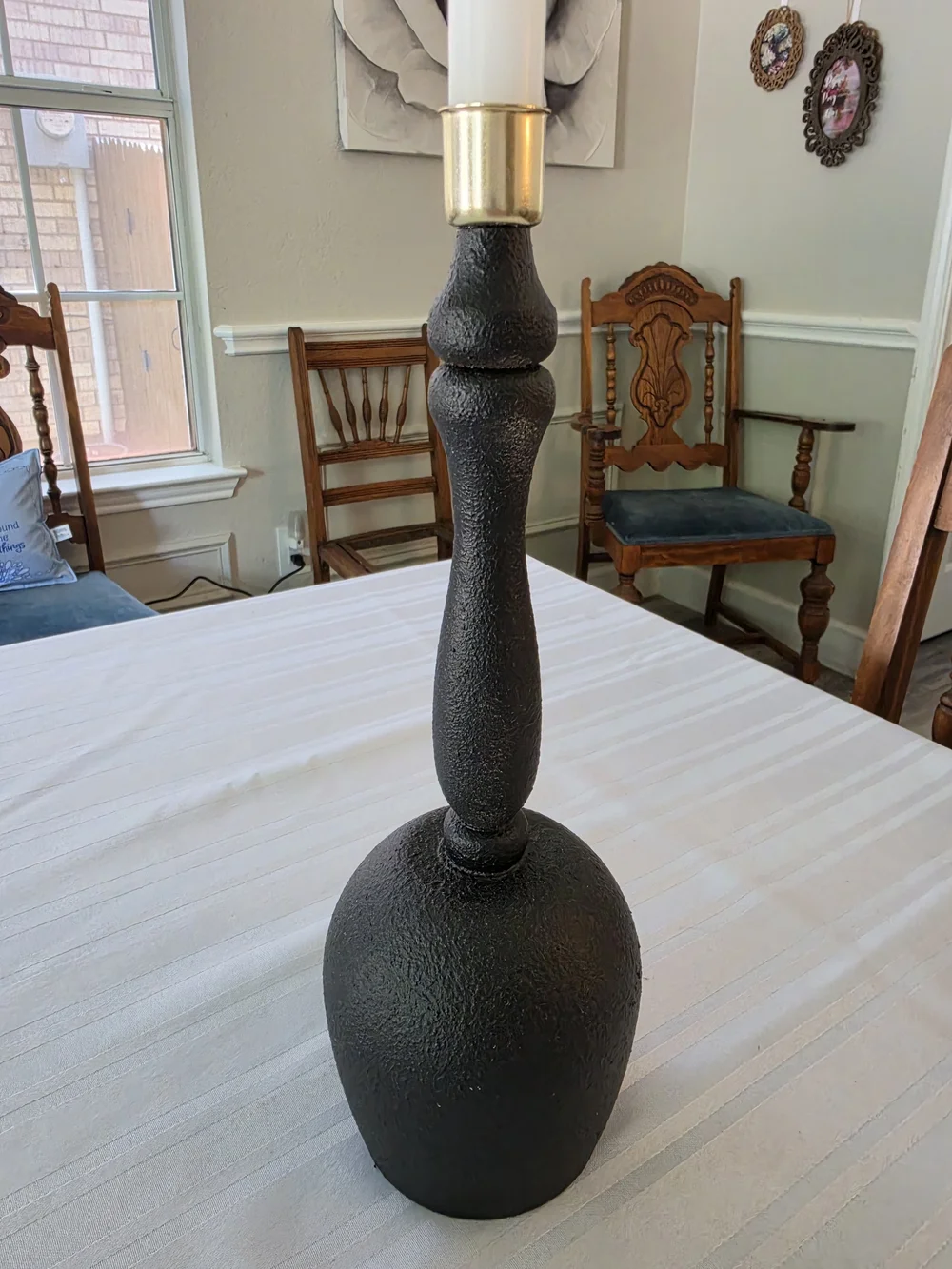 Black and gold taper candlestick holder Bulbous base Sleek turned spindle neck